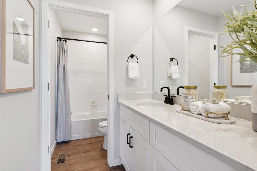 A bathroom with a tub sink and toilet. A bathroom with a tub sink and toilet.