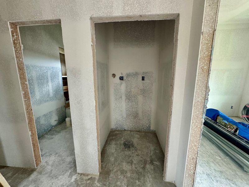 The doorway in the center of the photo is the laundry room, perfect for stackable washer, and dryer