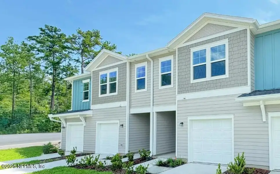 Front exterior of a new home in Silver Falls Townhomes at Silverleaf, St. Augustine, FL, highlighting curb appeal (Image 1). Front exterior of a new home in Silver Falls Townhomes at Silverleaf, St. Augustine, FL, highlighting curb appeal (Image 1).