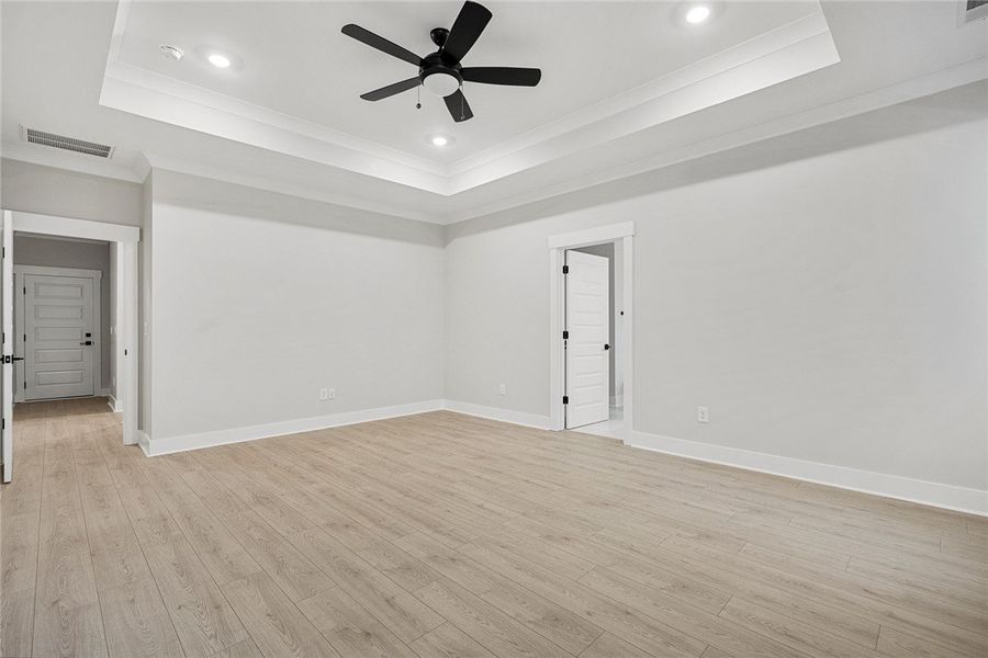 A spacious bedroom with a contemporary ceiling fan A spacious bedroom with a contemporary ceiling fan