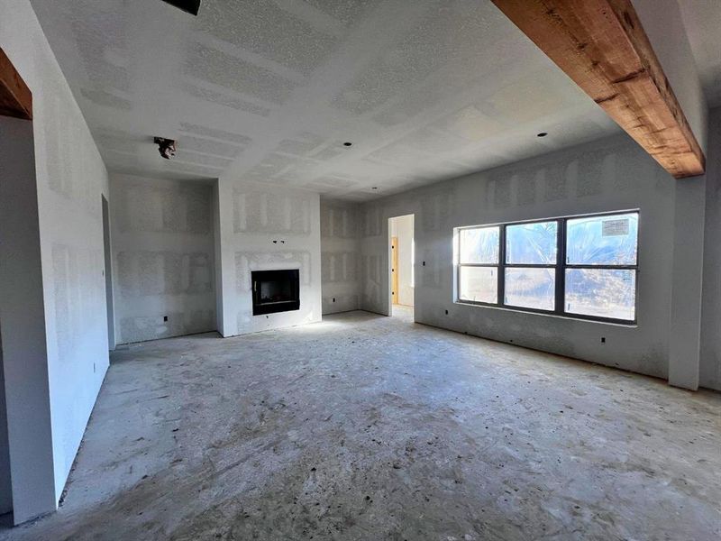 Living room with wood burning fireplace and lots of natural light