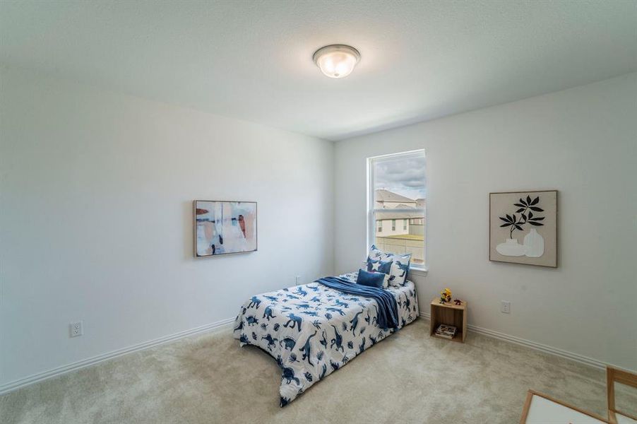 Bedroom featuring carpet floors and baseboards Bedroom featuring carpet floors and baseboards