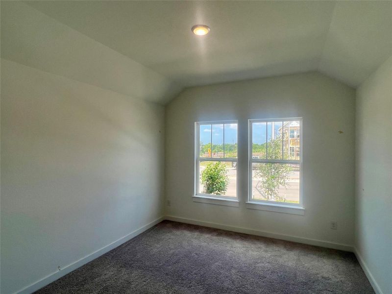 Bonus room featuring lofted ceiling and carpet flooring