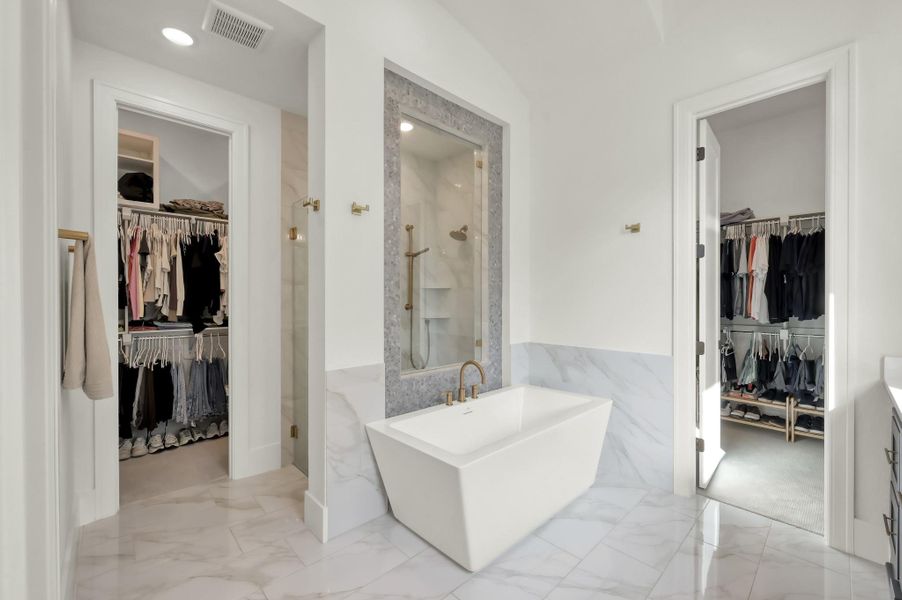 The spa-inspired bath features a freestanding soaking tub and separate walk-in shower.