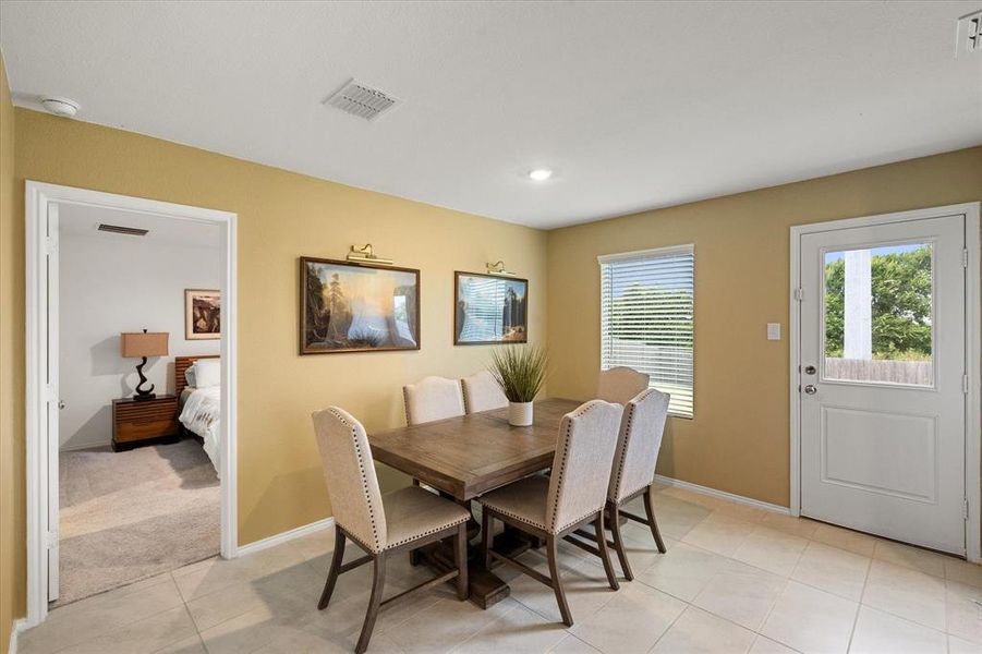 Dining space featuring light tile patterned flooring and recessed lighting