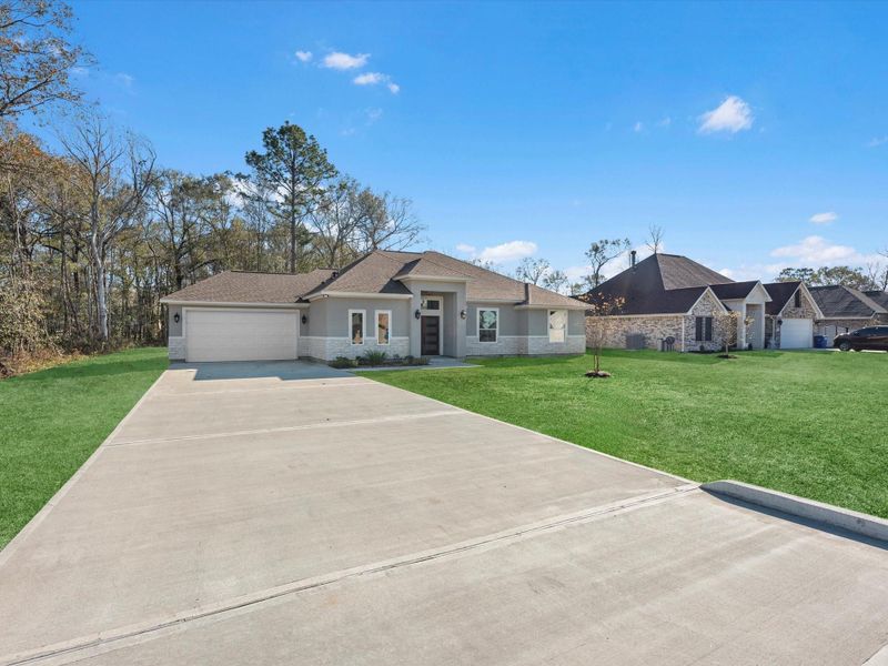 Front exterior of a new home in , Dayton, TX, highlighting curb appeal (Image 24).