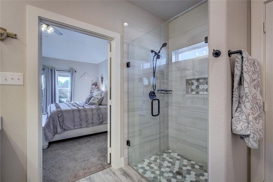 Bathroom featuring hardwood / wood-style flooring and walk in shower