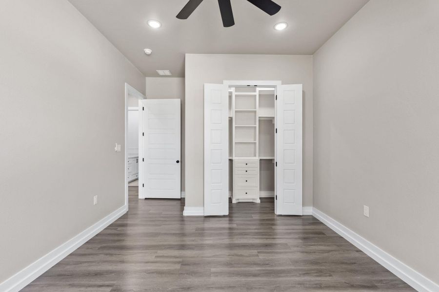 Integrated shelving and drawers create a well-organized storage solution in this bedroom. Integrated shelving and drawers create a well-organized storage solution in this bedroom.