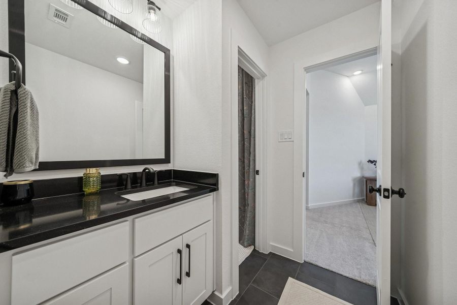 The hall bath for Bedrooms #3 and #4, which connects directly to Bedroom#3 as well as the hall.