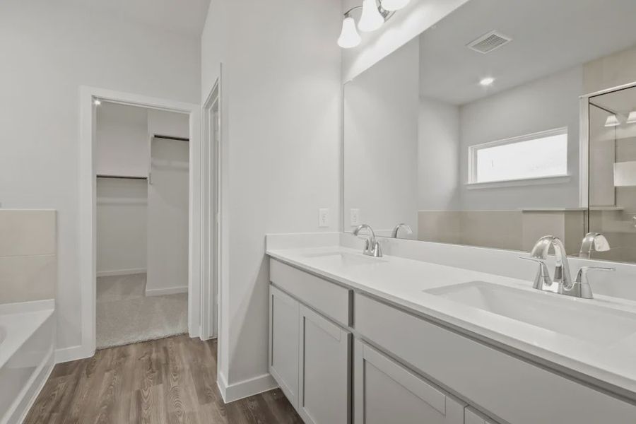 A bathroom with a large mirror.