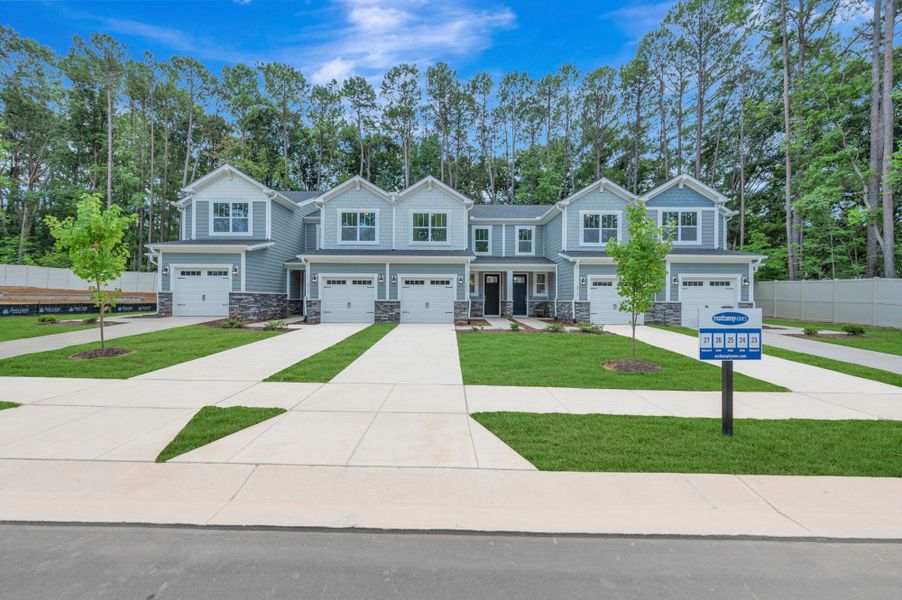 Front exterior of a new home in Ashmore Townes, Garner, NC, highlighting curb appeal (Image 1). Front exterior of a new home in Ashmore Townes, Garner, NC, highlighting curb appeal (Image 1).