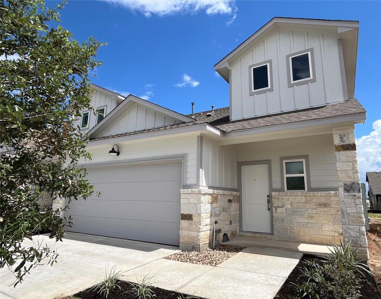 Front exterior of a new home in Wellspring, Round Rock, TX, highlighting curb appeal (Image 16). Front exterior of a new home in Wellspring, Round Rock, TX, highlighting curb appeal (Image 16).