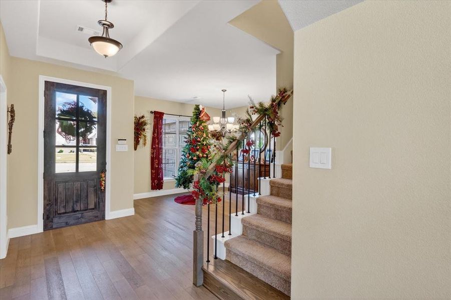 Foyer entrance featuring hardwood / wood-style flooring and stairway Foyer entrance featuring hardwood / wood-style flooring and stairway