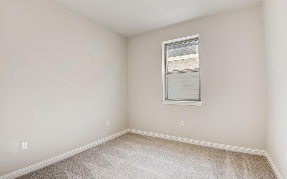 Unfurnished room featuring light colored carpet and baseboards