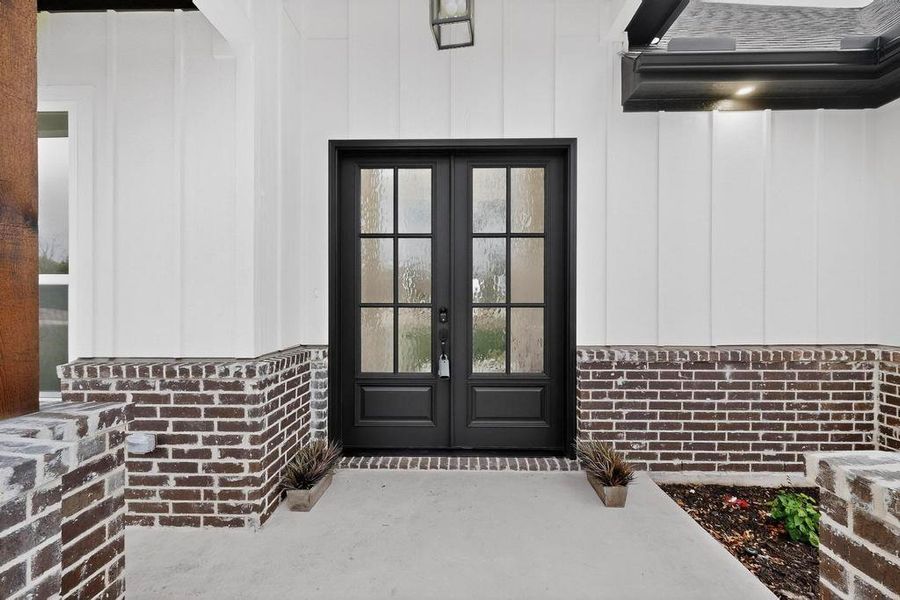 View of exterior entry featuring french doors and brick siding View of exterior entry featuring french doors and brick siding