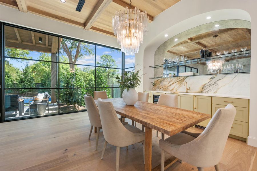 Fine wood finishes and a built-in bar elevate this elegant dining space.