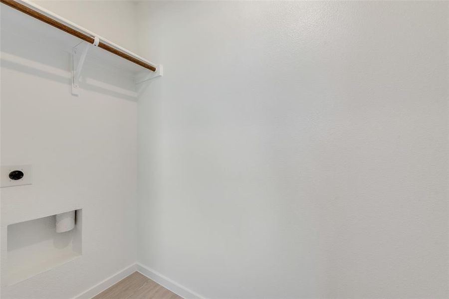 Laundry room featuring hardwood / wood-style flooring and electric dryer hookup