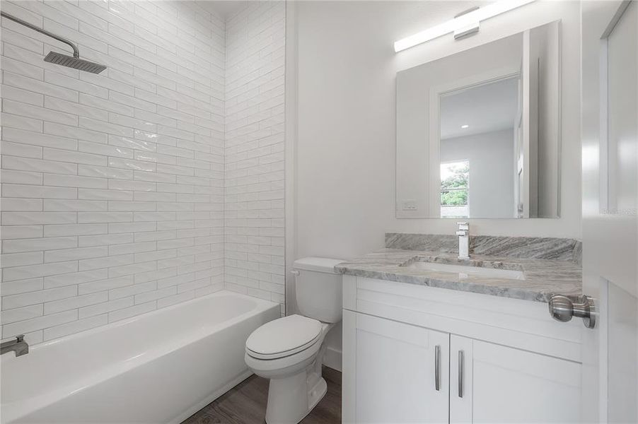 Bathroom 2. Specific finish colors may be differ. Photo is from another completed unit.