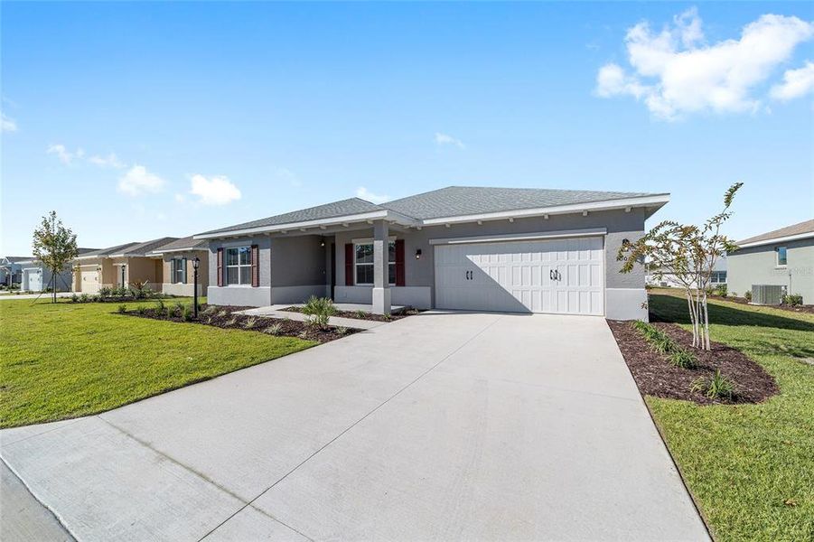 Front exterior of a new home in On Top of the World Communities, Ocala, FL, highlighting curb appeal (Image 1). Front exterior of a new home in On Top of the World Communities, Ocala, FL, highlighting curb appeal (Image 1).