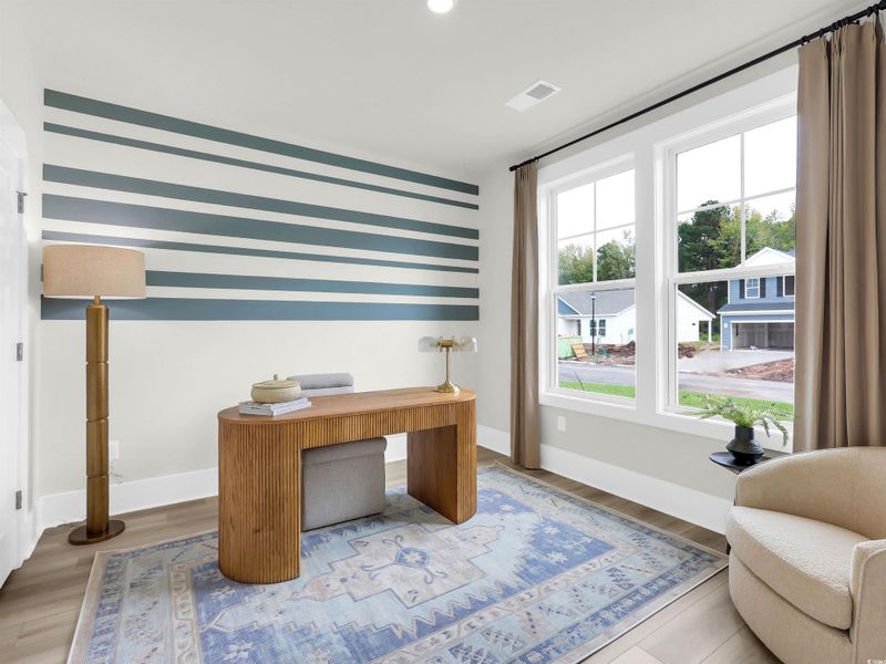 Office space with wood finished floors and recessed lighting