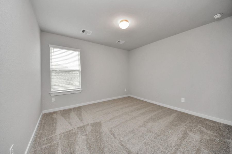 Secondary bedroom features plush carpeting, large windows that let in plenty of naturallight, bright paint, and spacious closets. Sample photo of completed home with similar floor plan. Actual colors and selections may vary. Secondary bedroom features plush carpeting, large windows that let in plenty of naturallight, bright paint, and spacious closets. Sample photo of completed home with similar floor plan. Actual colors and selections may vary.