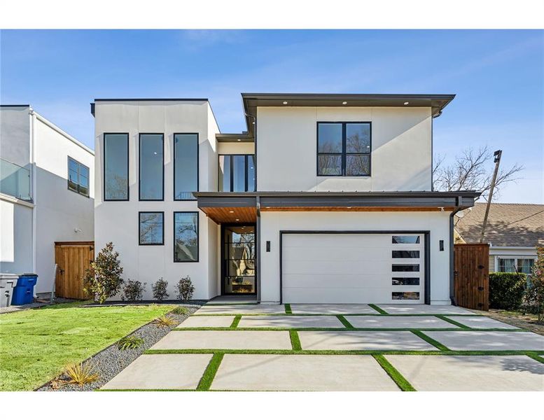 Modern home with a garage and a front lawn