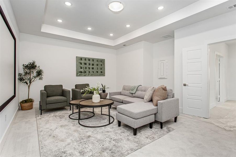 Living room with light carpet and a tray ceiling