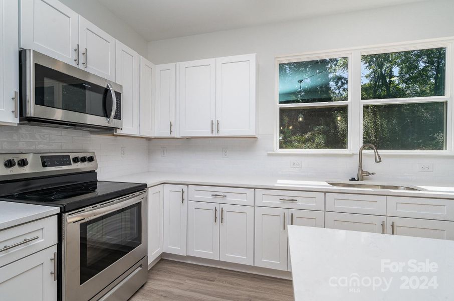 Representative Photo. Electric oven with mounted microwave