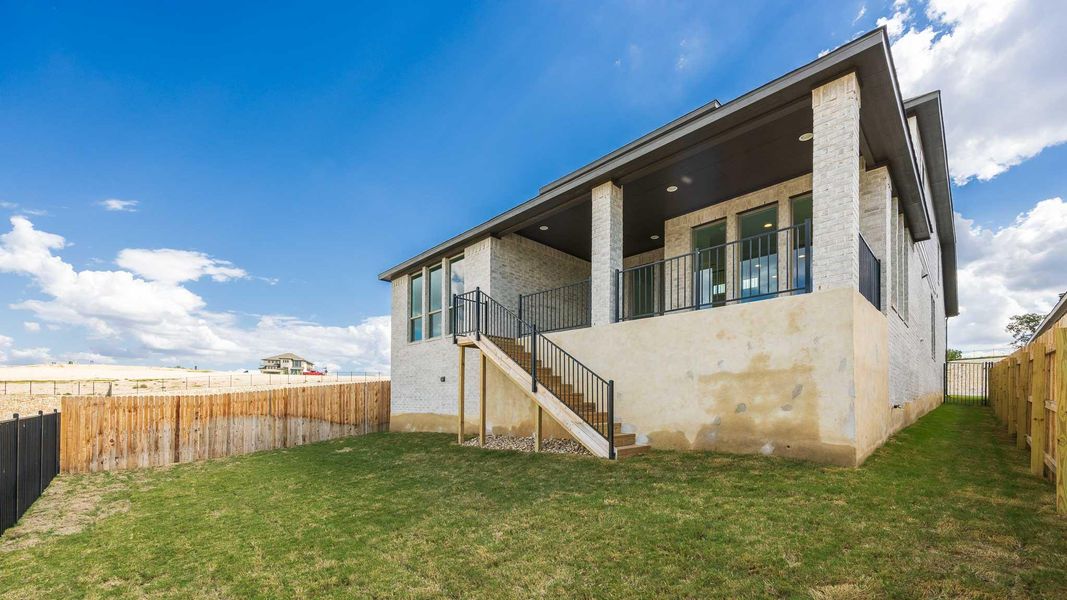 Back of house featuring stairs, a fenced backyard, brick siding, and a patio Back of house featuring stairs, a fenced backyard, brick siding, and a patio