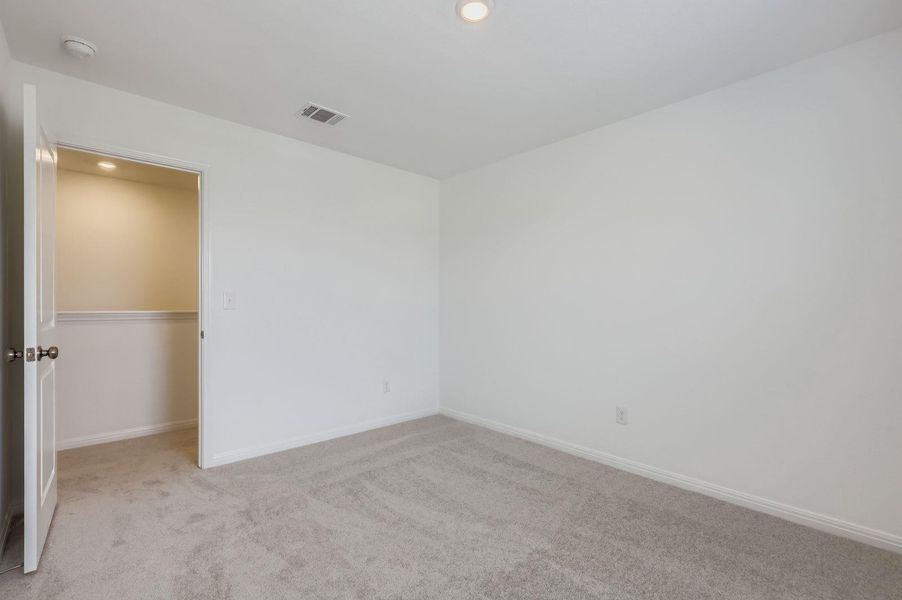 Empty room with carpet flooring and recessed lighting Empty room with carpet flooring and recessed lighting