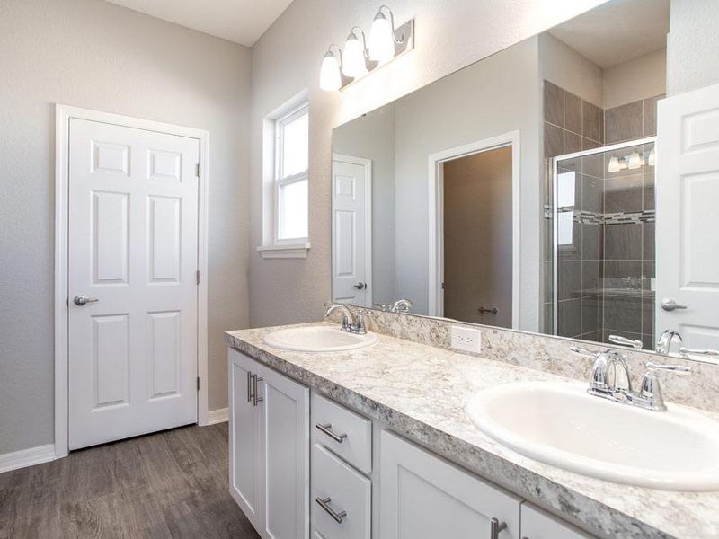 The en-suite owner`s bath also includes a tiled shower, private toilet, and linen closet - Savannah home plan by Highland Homes Homes