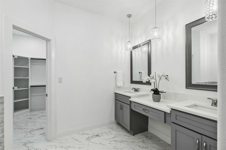 Bathroom featuring dual bowl vanity and tile patterned flooring