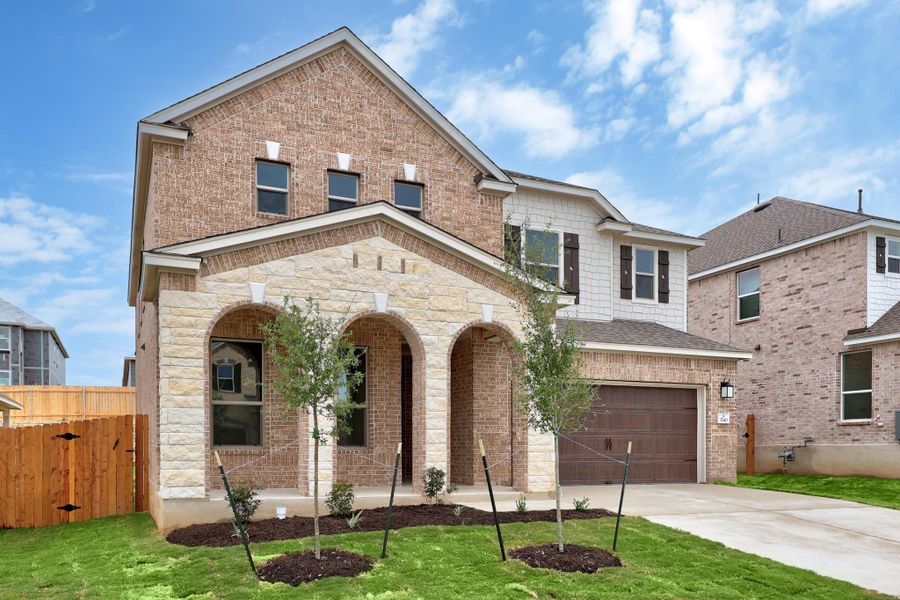 Front exterior of a new home in Salerno - Classic Collection, Round Rock, TX, highlighting curb appeal (Image 20). Front exterior of a new home in Salerno - Classic Collection, Round Rock, TX, highlighting curb appeal (Image 20).