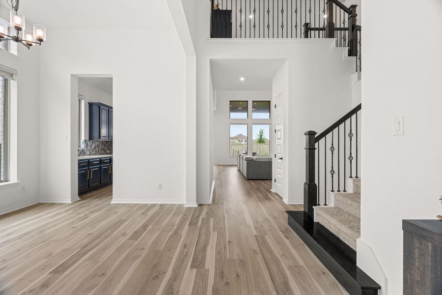 An open floorplan with hardwood flooring seamlessly connects the living spaces and kitchen. An open floorplan with hardwood flooring seamlessly connects the living spaces and kitchen.