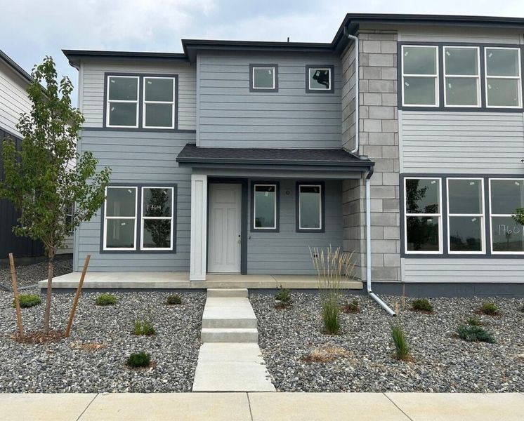 Front exterior of a new home in Westside Crossing Townhomes, Berthoud, CO, highlighting curb appeal (Image 1).