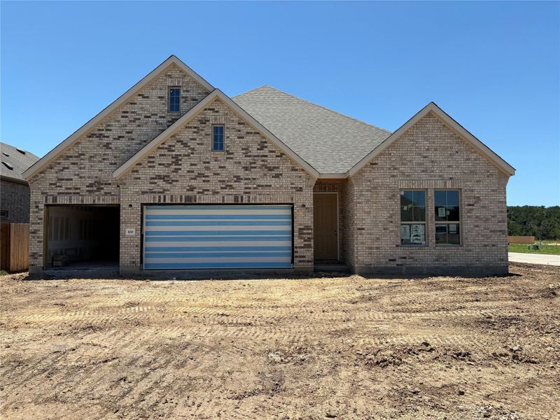 View of front facade featuring driveway, brick siding, and an attached garage View of front facade featuring driveway, brick siding, and an attached garage