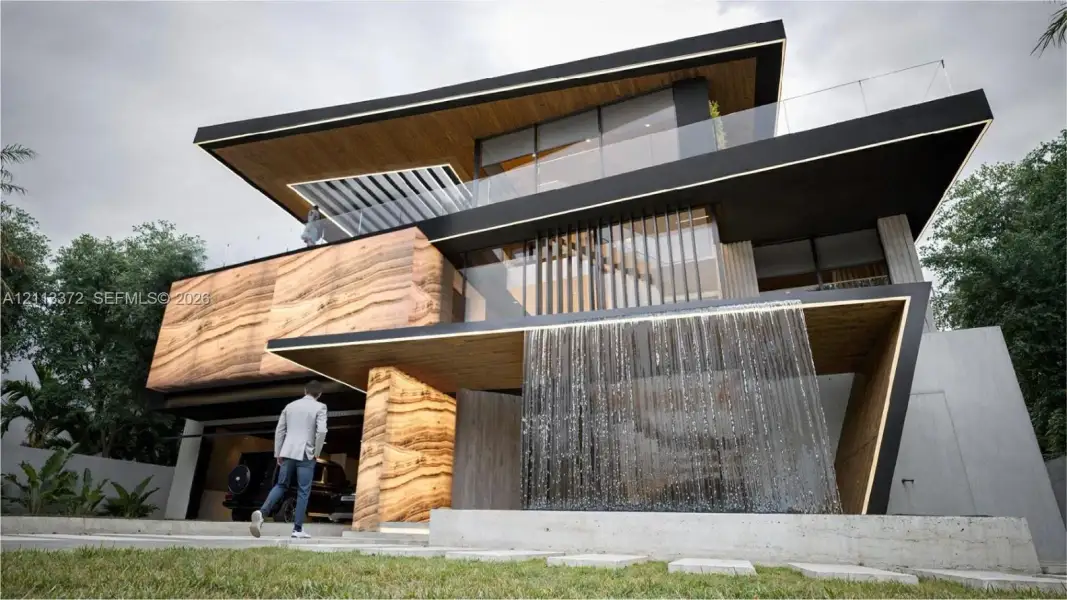 Contemporary multi-level exterior featuring a stone-clad facade, integrated water feature, wood-finish soffits, and glass-paneled balconies