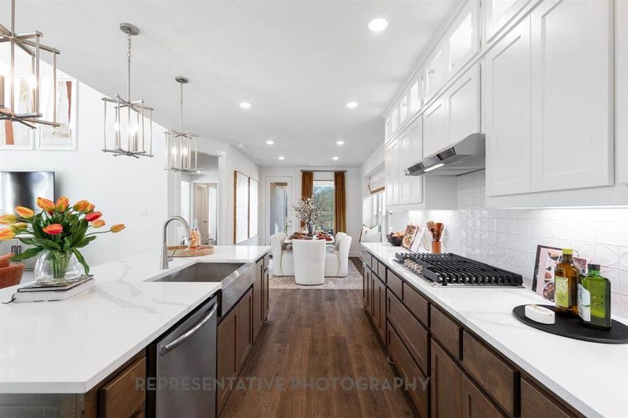 Kitchen with dark wood-style floors, glass insert cabinets, hanging light fixtures, appliances with stainless steel finishes, and recessed lighting