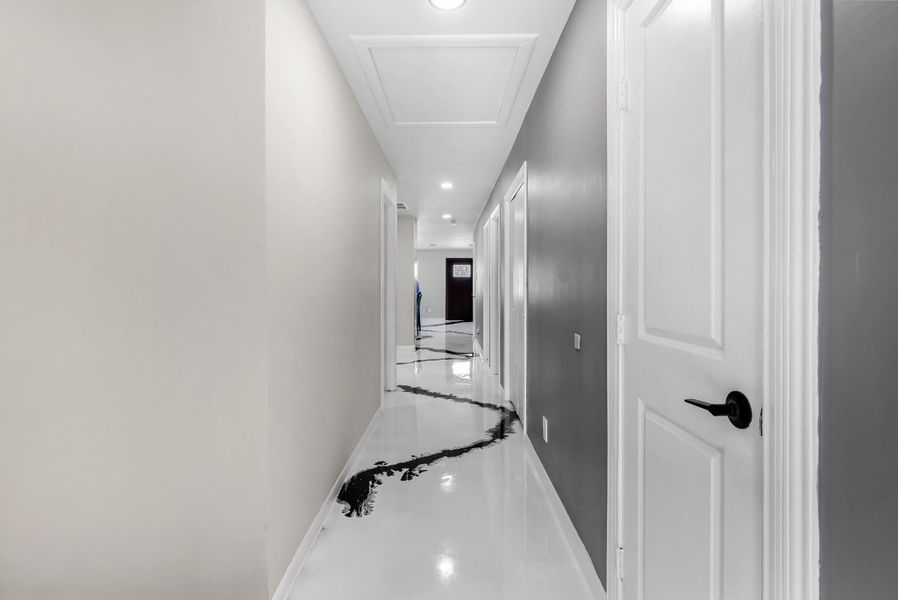Corridor with recessed lighting and inlaid floor details