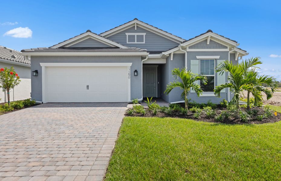 Front exterior of a new home in Del Webb Oak Creek, North Fort Myers, FL, highlighting curb appeal (Image 2). Front exterior of a new home in Del Webb Oak Creek, North Fort Myers, FL, highlighting curb appeal (Image 2).