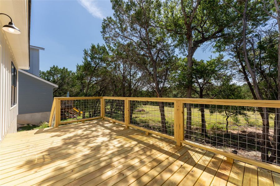 A peaceful spot overlooking the backyard and quiet greenspace beyond—perfect for morning coffee, an evening drink, or simply watching the Hill Country wildlife.