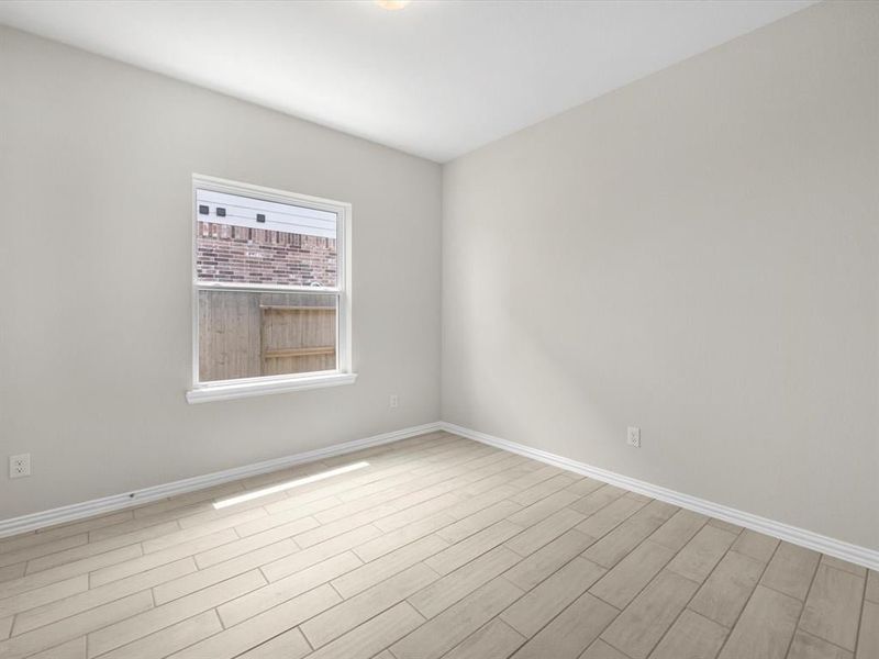A room with a tile floor and a window. A room with a tile floor and a window.