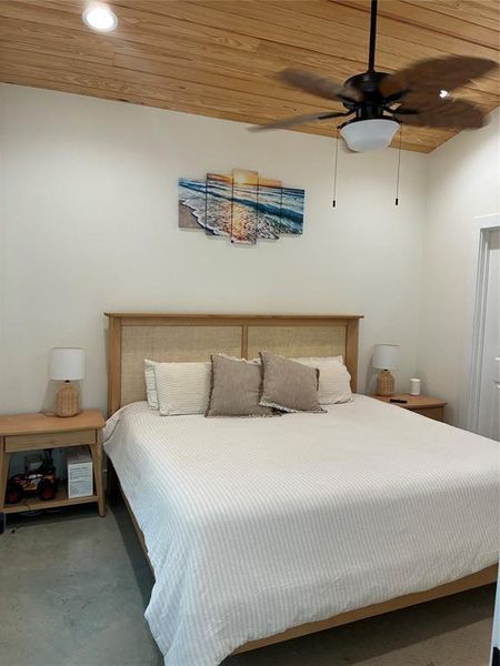 Bedroom featuring wooden ceiling, recessed lighting, concrete floors, and ceiling fan