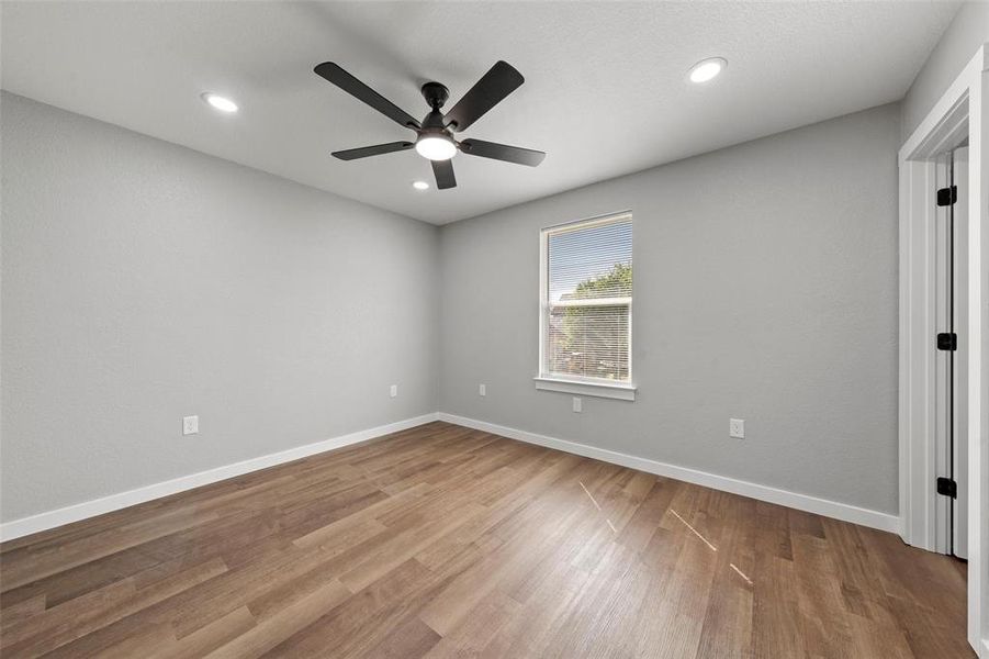 Unfurnished room featuring ceiling fan, wood finished floors, and recessed lighting Unfurnished room featuring ceiling fan, wood finished floors, and recessed lighting