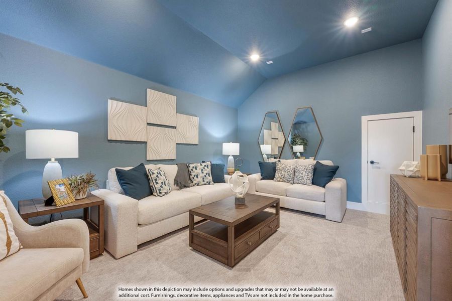 Living room with vaulted ceiling, blue walls, two cream sofas, and wood coffee table on carpet