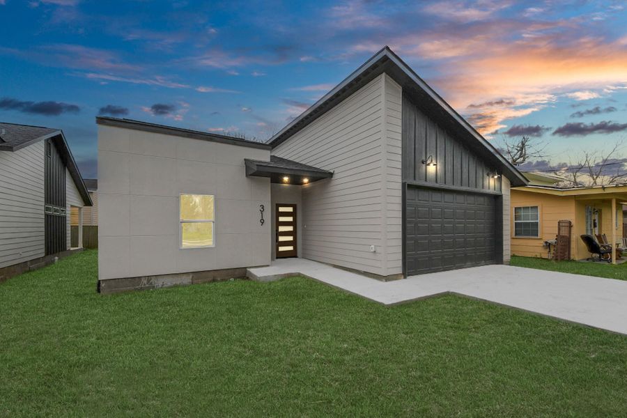 A covered entryway provides a warm and sophisticated welcome for guests.