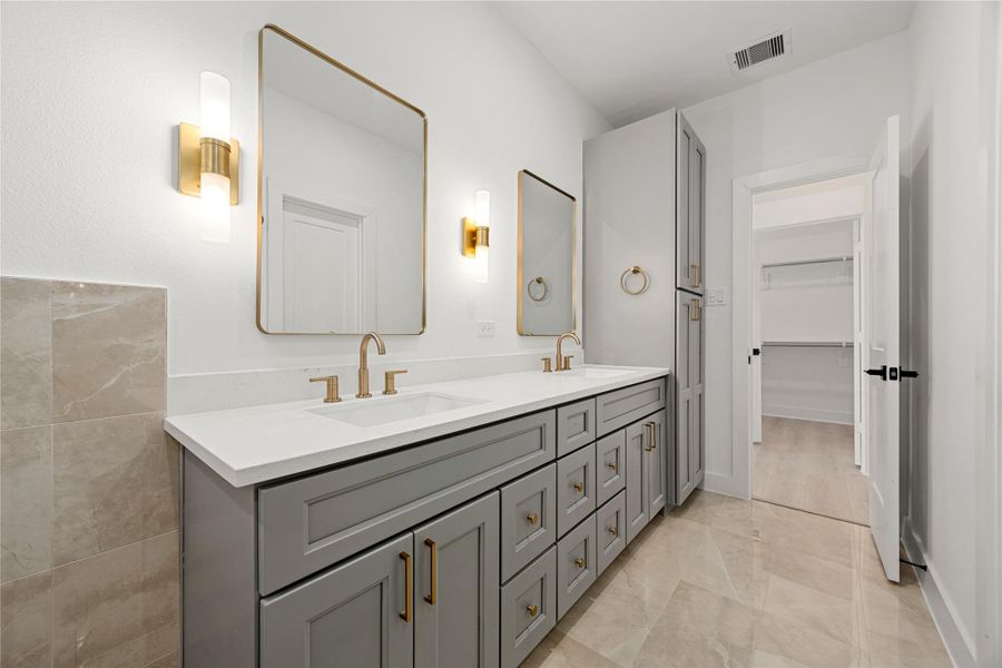 This primary bathroom is definitely move-in ready! Featuring grey cabinets with light countertops, spacious walk-in closet with shelving, high ceilings, neutral paint with sleek and modern finishes. This primary bathroom is definitely move-in ready! Featuring grey cabinets with light countertops, spacious walk-in closet with shelving, high ceilings, neutral paint with sleek and modern finishes.