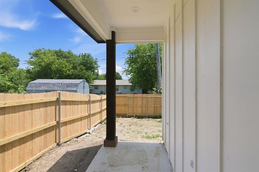Covered patio featuring a dark support column, recessed lighting, and a board and batten exterior wall