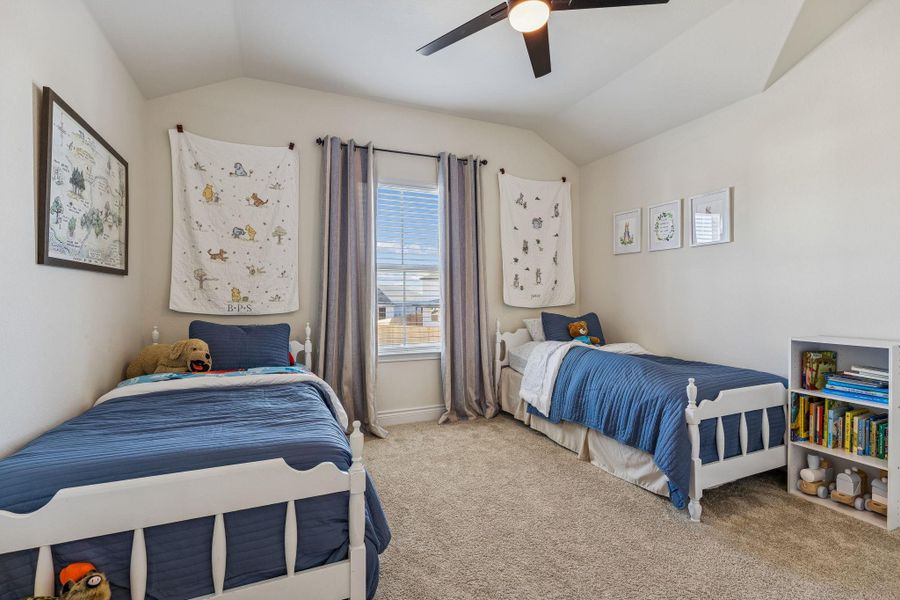 Fourth bedroom upstairs with ceiling fan and carpet