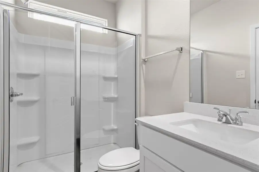 Bathroom featuring a stall shower and vanity